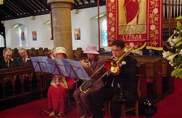 Nicola, Helen and Jonathan playing some music in the church looked on by Rodney and Michael